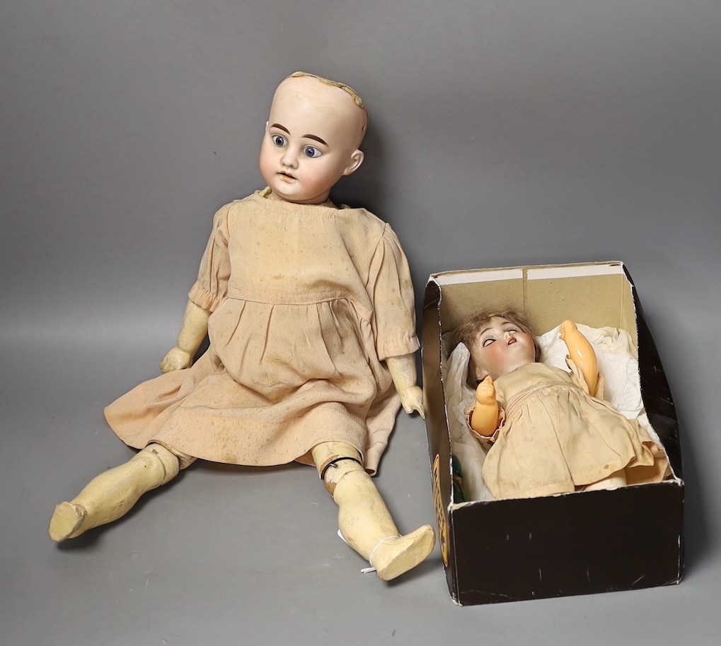 An Armand Marseille bisque headed doll, another German bisque headed doll and a miniature bisque doll.